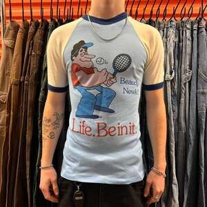 True Vintage 70s Life. Be In It. Norm Tennis Ringer Raglan Tee — Baby Blue
